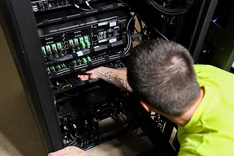 Thompson Electronics Company's audiovisual technician  adjusting wiring in a  tower
